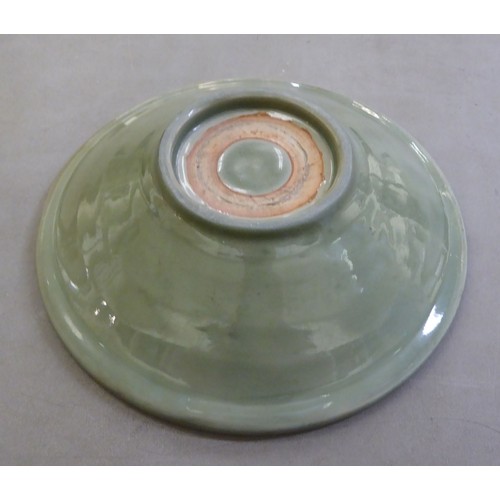 54 - A late 19thC Chinese celadon glazed porcelain, footed, shallow dish with faintly ribbed sides  12