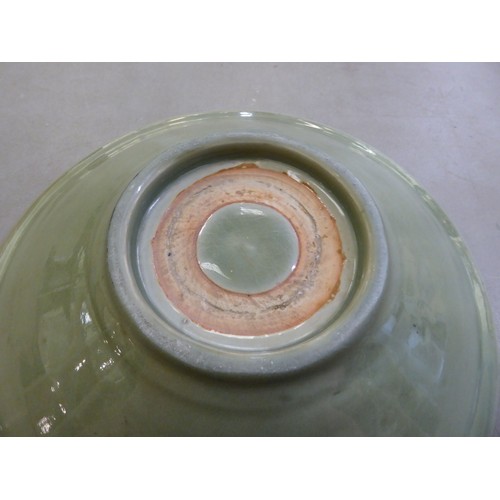 54 - A late 19thC Chinese celadon glazed porcelain, footed, shallow dish with faintly ribbed sides  12