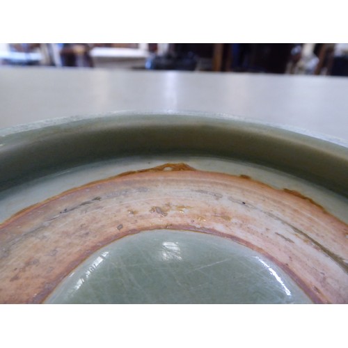 54 - A late 19thC Chinese celadon glazed porcelain, footed, shallow dish with faintly ribbed sides  12