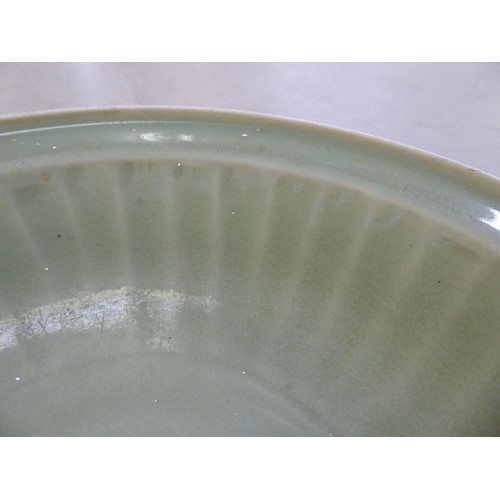 54 - A late 19thC Chinese celadon glazed porcelain, footed, shallow dish with faintly ribbed sides  12