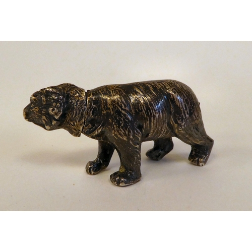 1 - An early 20thC silver miniature brown bear pepper pot  bears an indistinct marks & an import mar... 