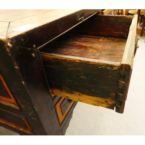 103 - A late 19th/early 20thC elm and fielded panelled kneehole work table, the mitred top over an arrange... 