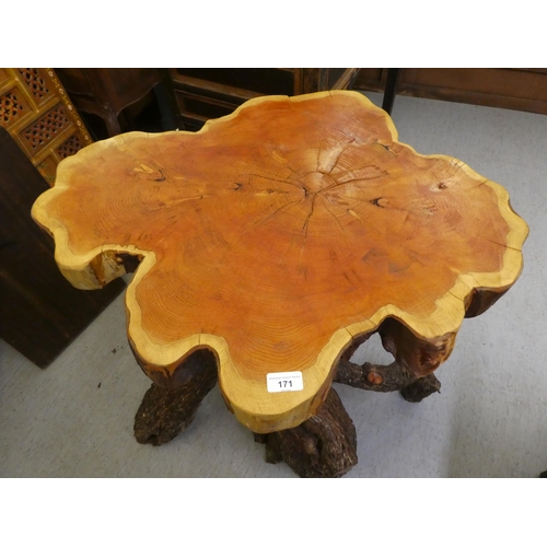 107 - A rough cut timber garden table, the crosscut, one piece top raised on a bark finished base  35