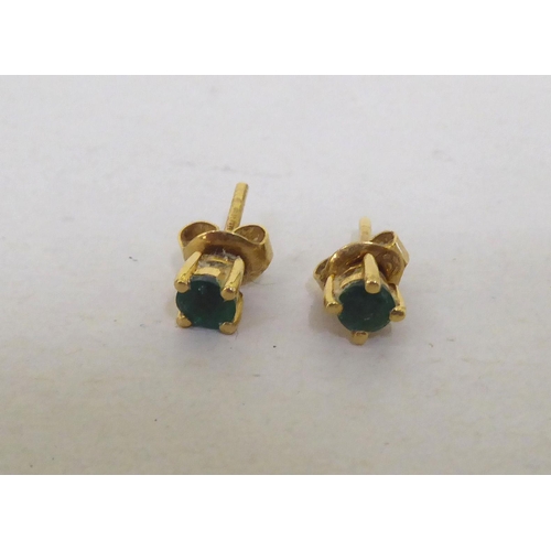 112 - A pair of 18ct gold emerald stud earrings