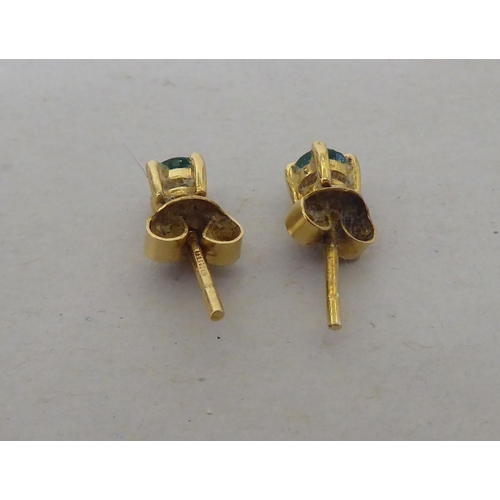 112 - A pair of 18ct gold emerald stud earrings