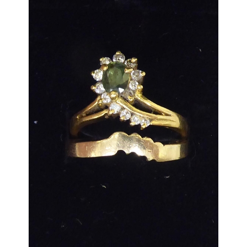 113 - An 18ct gold diamond, emerald and diamond crossover ring; and a 14ct gold herringbone band