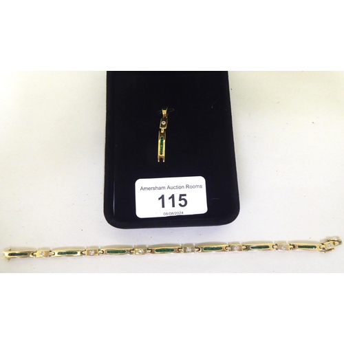 115 - A 14ct gold bracelet, set with diamonds and baguette cut emeralds