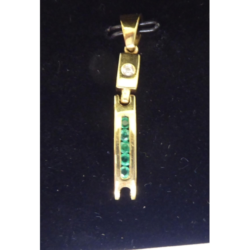 115 - A 14ct gold bracelet, set with diamonds and baguette cut emeralds