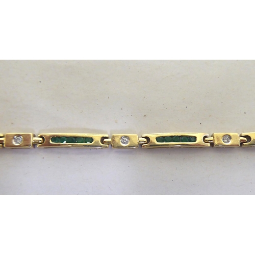 115 - A 14ct gold bracelet, set with diamonds and baguette cut emeralds