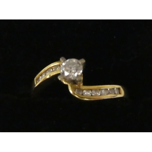 126 - An 18ct gold crossover set diamond ring 