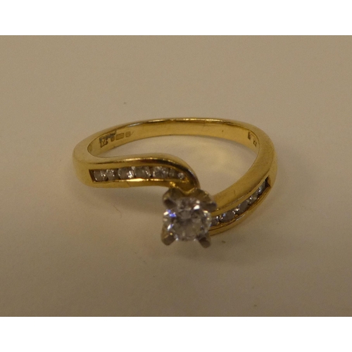 126 - An 18ct gold crossover set diamond ring 