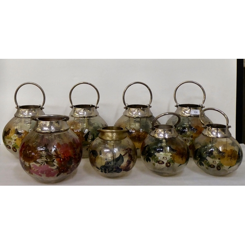 132 - A set of seven painted model glass T-light garden lanterns  largest 10