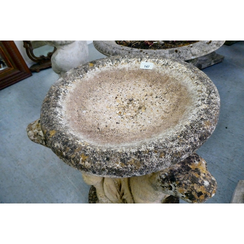 147 - A composition stone bird bath, the pedestal fashioned as three back-to-back otters  24