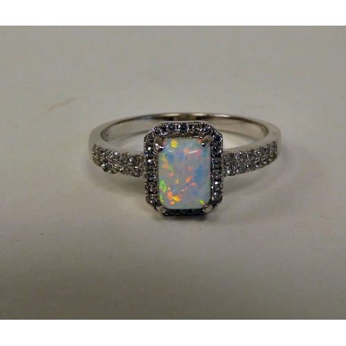 149 - A silver coloured metal opal and cubic zirconia set ring 