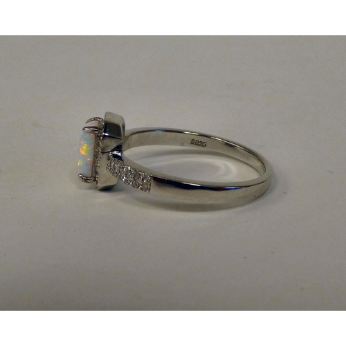 149 - A silver coloured metal opal and cubic zirconia set ring 