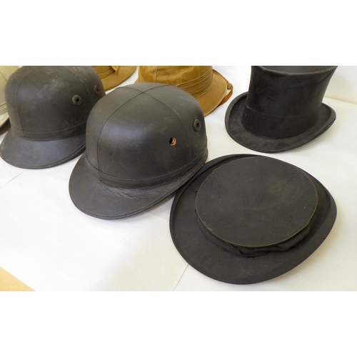 15 - A selection of formal and other hats/helmets: to include two tan coloured pith helmets