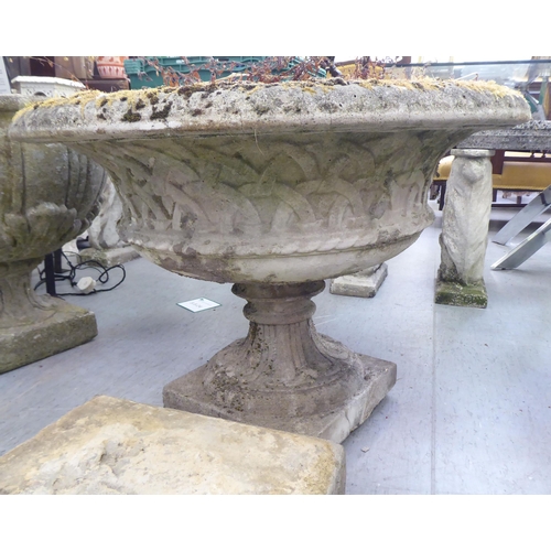 154 - A pair of composition stone pedestal planters, on separate square plinths  23