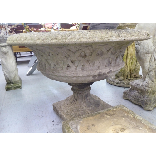 154 - A pair of composition stone pedestal planters, on separate square plinths  23