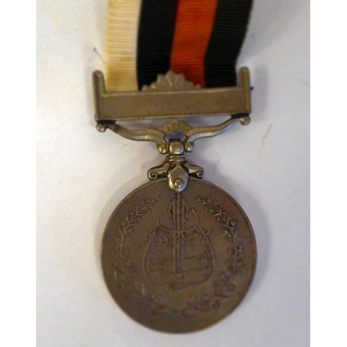 155 - Five 10/- banknotes, two circa 1950s medals; and a leaf brooch