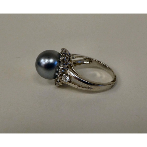 157 - A silver coloured metal ring, set with a river pearl and cubic zirconia 