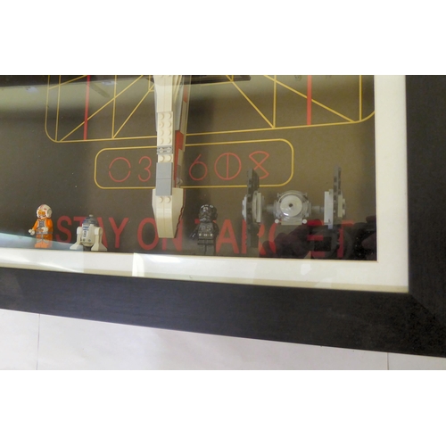 172 - A Lego Star Wars themed display, comprising three characters and an X-Wing fighter, in a deep set, g... 