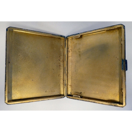 178 - A silver engine turned folding cigarette case, set with an enamelled plaque, depicting a glamour gir... 