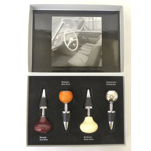 181 - A novelty four piece wine bottle stopper set for Mercedes, each top fashioned as a gear stick  ... 