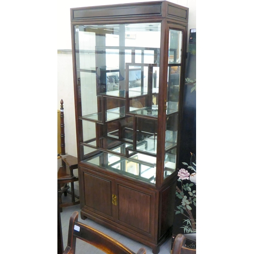 20 - A post World War II Chinese hardwood and glazed shodhana style layout display cabinet, over a two cu... 