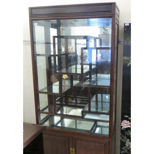 20 - A post World War II Chinese hardwood and glazed shodhana style layout display cabinet, over a two cu... 