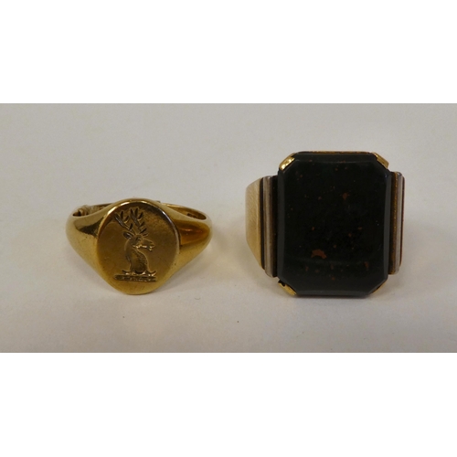 22 - A 9ct gold signet ring with an engraved armorial and a gold coloured metal signet ring, set with a b... 