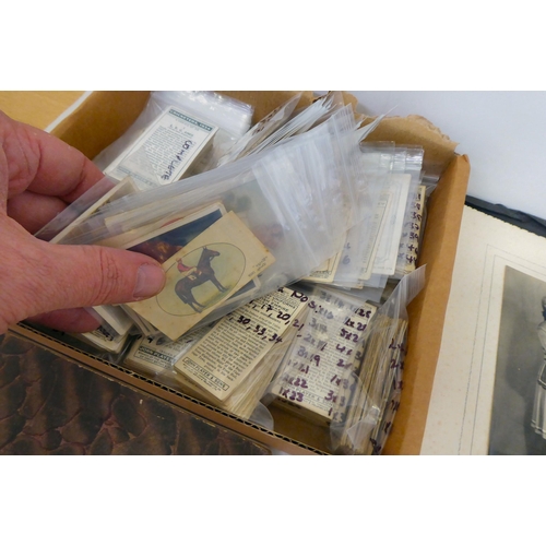 25 - Uncollated used postage stamps; banknotes; cigarette cards; postcards; and handwritten ephemera