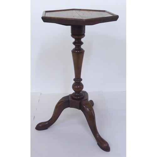 3 - A 19thC style walnut wine table with a quarter veneered hexagonal top, over a tapered column, raised... 