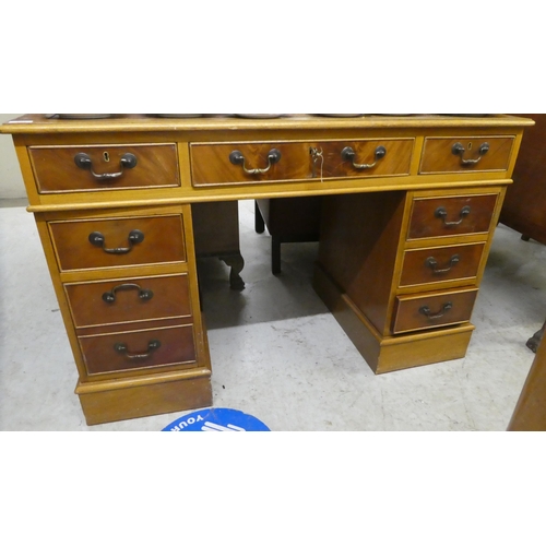 304 - A modern mahogany nine drawer, twin pedestal desk, on a plinth  30