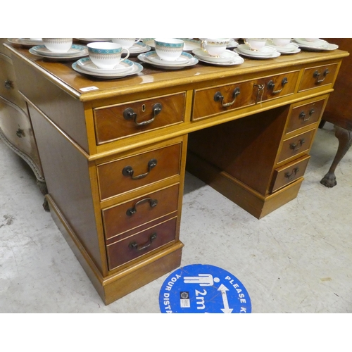 304 - A modern mahogany nine drawer, twin pedestal desk, on a plinth  30