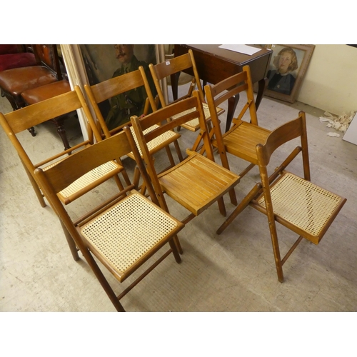 313 - Seven similar, mainly beech framed folding chairs with either caned or panelled seats