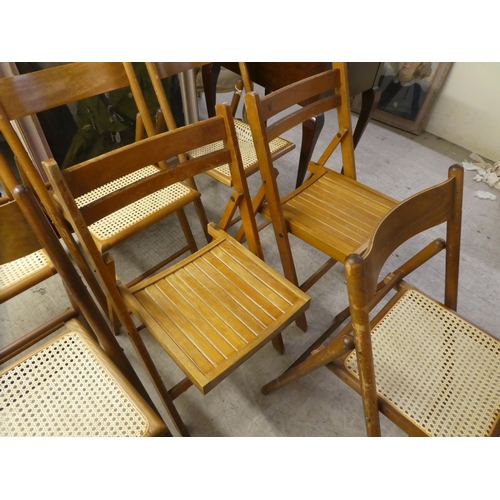 313 - Seven similar, mainly beech framed folding chairs with either caned or panelled seats