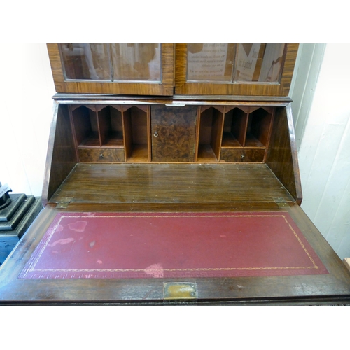 319 - A 20thC crossbanded, walnut veneered bureau bookcase, the upper section with a pair of glazed doors ... 