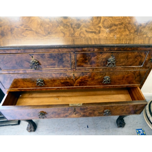 319 - A 20thC crossbanded, walnut veneered bureau bookcase, the upper section with a pair of glazed doors ... 