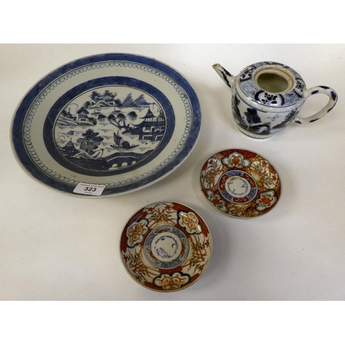 323 - 19thC and later Oriental ceramics: to include a Chinese porcelain charger, decorated in blue and whi... 