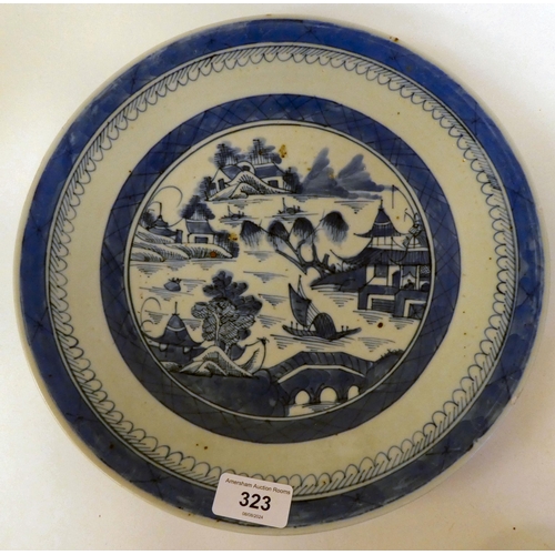 323 - 19thC and later Oriental ceramics: to include a Chinese porcelain charger, decorated in blue and whi... 