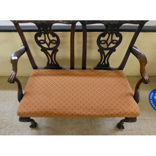 333 - An early/mid 20thC Georgian design,  mahogany twin carved, splat back, open arm two person settee, r... 