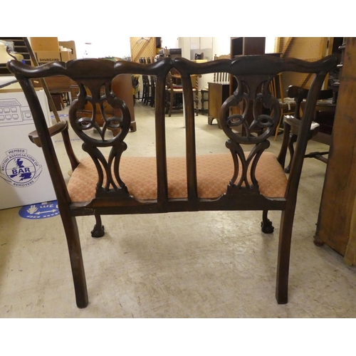 333 - An early/mid 20thC Georgian design,  mahogany twin carved, splat back, open arm two person settee, r... 