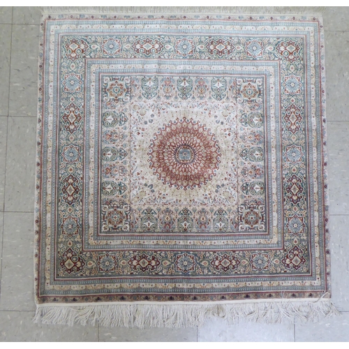 338 - An Iranian silk rug, woven in colours, around a central medallion  36