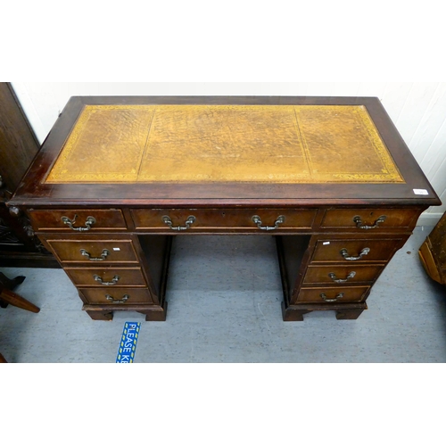 35 - A modern mahogany finished nine drawer, twin pedestal desk, the top set with a tooled scriber, raise... 