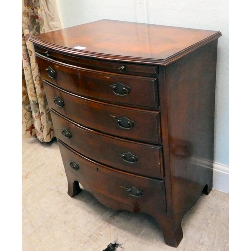 38 - A modern mahogany bowfront dressing chest with a brushing slide and four long drawers, raised on bra... 