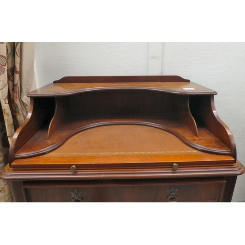 43 - A modern lady's mahogany finished writing desk with a single drawer, raised on turned legs  37