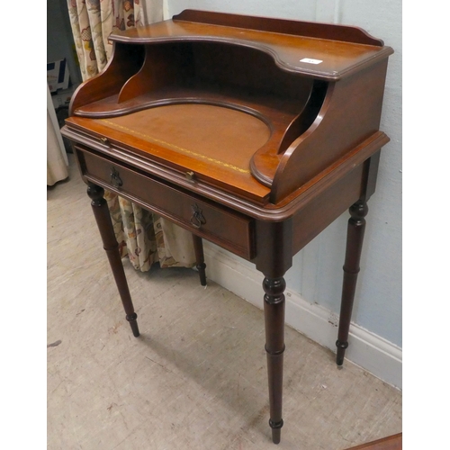 43 - A modern lady's mahogany finished writing desk with a single drawer, raised on turned legs  37