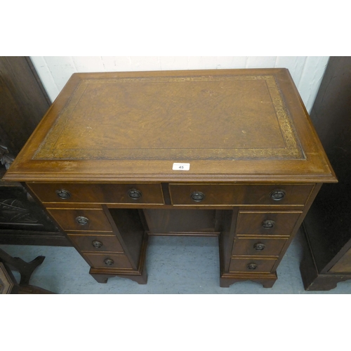 45 - A modern mahogany kneehole desk with a central cupboard and eight drawers, raised on bracket feet&nb... 