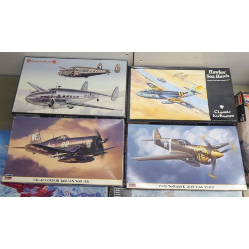 49 - 1/48 scale model kits: to include a Tamiya, Douglas A-1H Skyraider; and a P-40E Warhawk by Hasegawa&... 