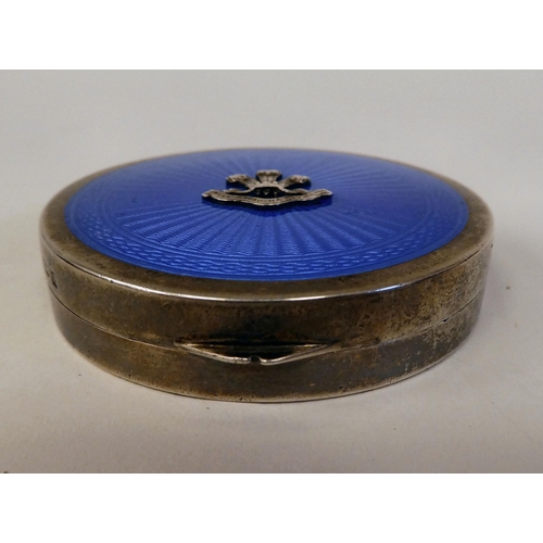 6 - A silver circular powder compact with a hinged, engine turned blue enamel lid and an applied emblem ... 